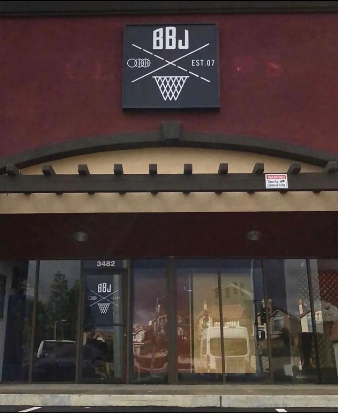 The BBJ Locker Room storefront, the BBJ crest-and-hoop sign mounted on the wall above the shop windows.