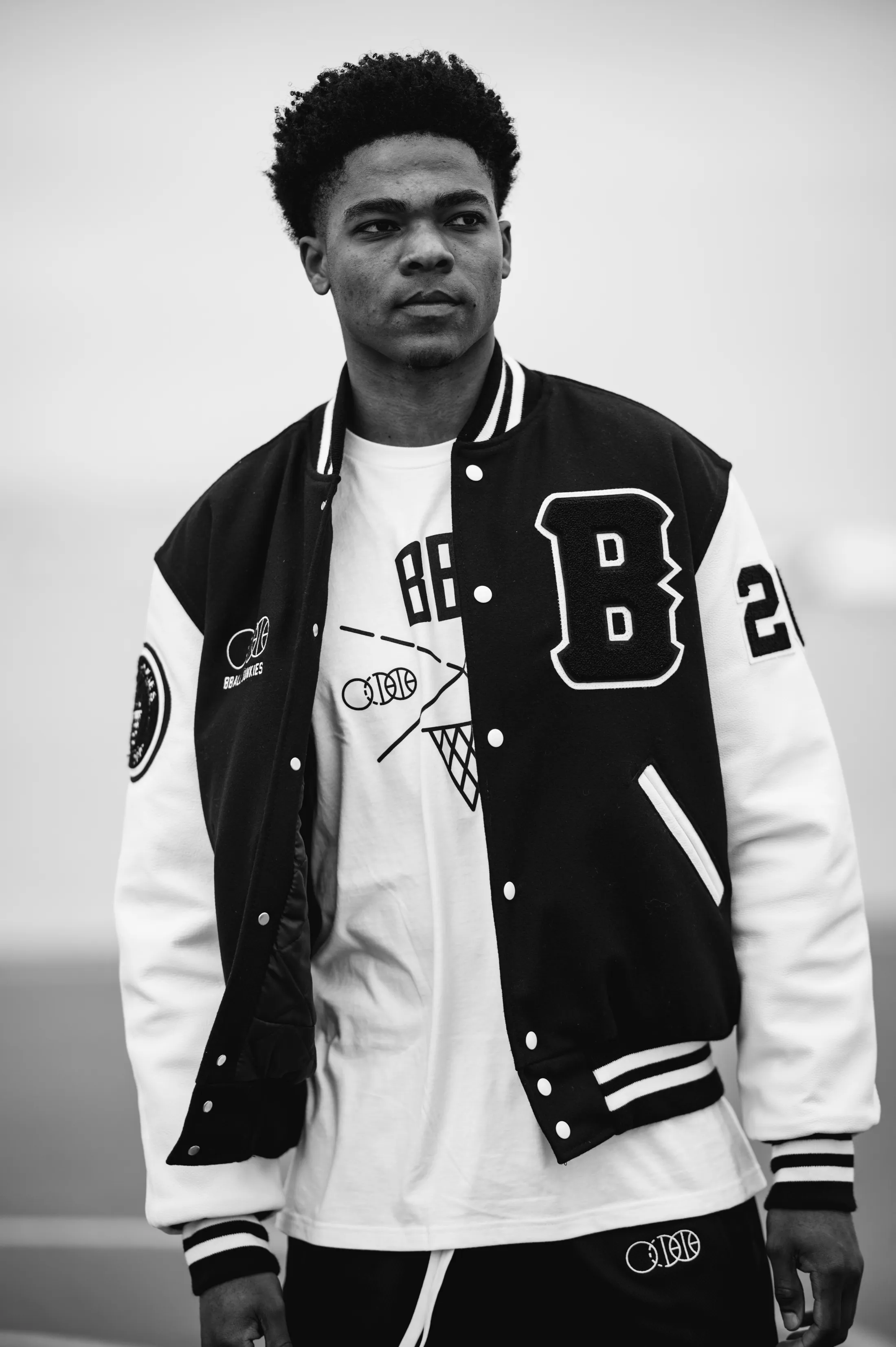 The BBJ Authentic Varsity Jacket — melton wool with leather sleeves and a chenille B patch — worn open over the BBJ crest tee, from the summer 2021 lookbook.